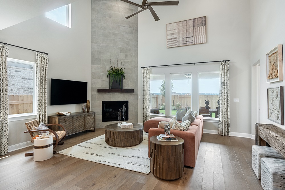 224 Amber Oak Lane Georgetown, TX 78628 - Photo 20 of 40 a living room with furniture a flat screen tv and a fireplace