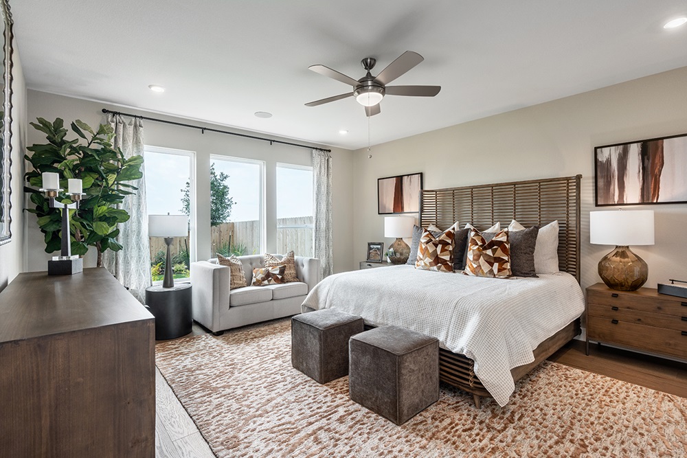 224 Amber Oak Lane Georgetown, TX 78628 - Photo 21 of 40 a bedroom with a large bed and a couch