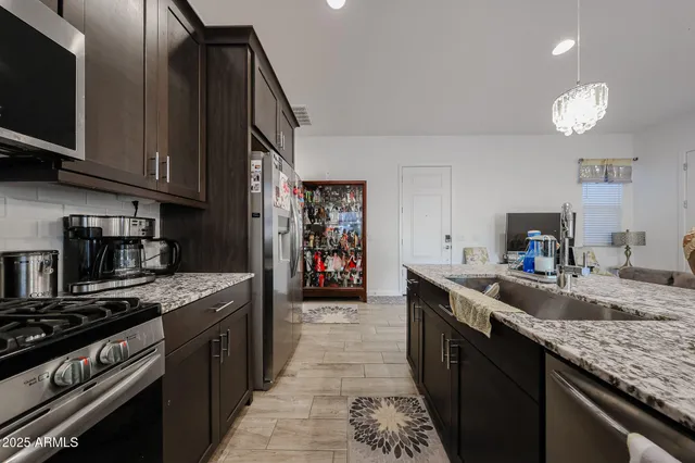 a kitchen with stainless steel appliances granite countertop a stove and a sink