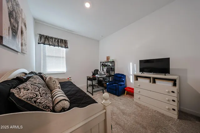 a living room with furniture and a piano