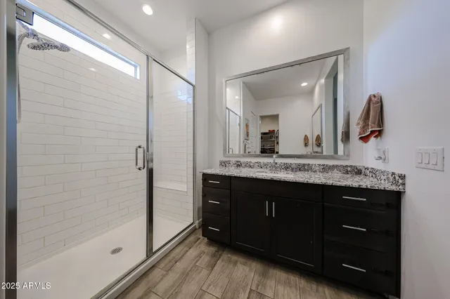 a bedroom with a bed a desk and chair