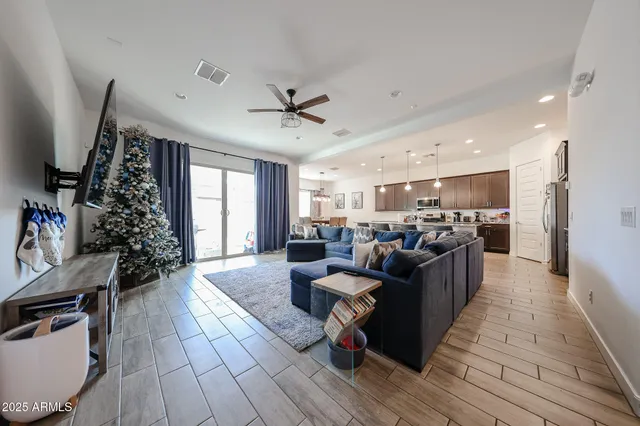 a living room with furniture and a wooden floor