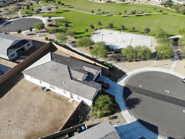 an aerial view of a house with a yard and plants
