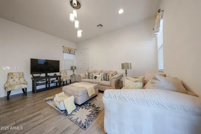 a bedroom with two beds and a flat screen tv
