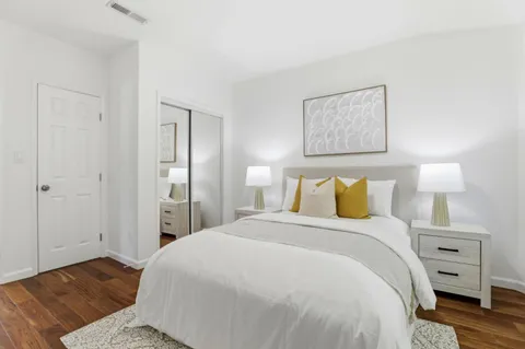 a bedroom with a bed and a night stand