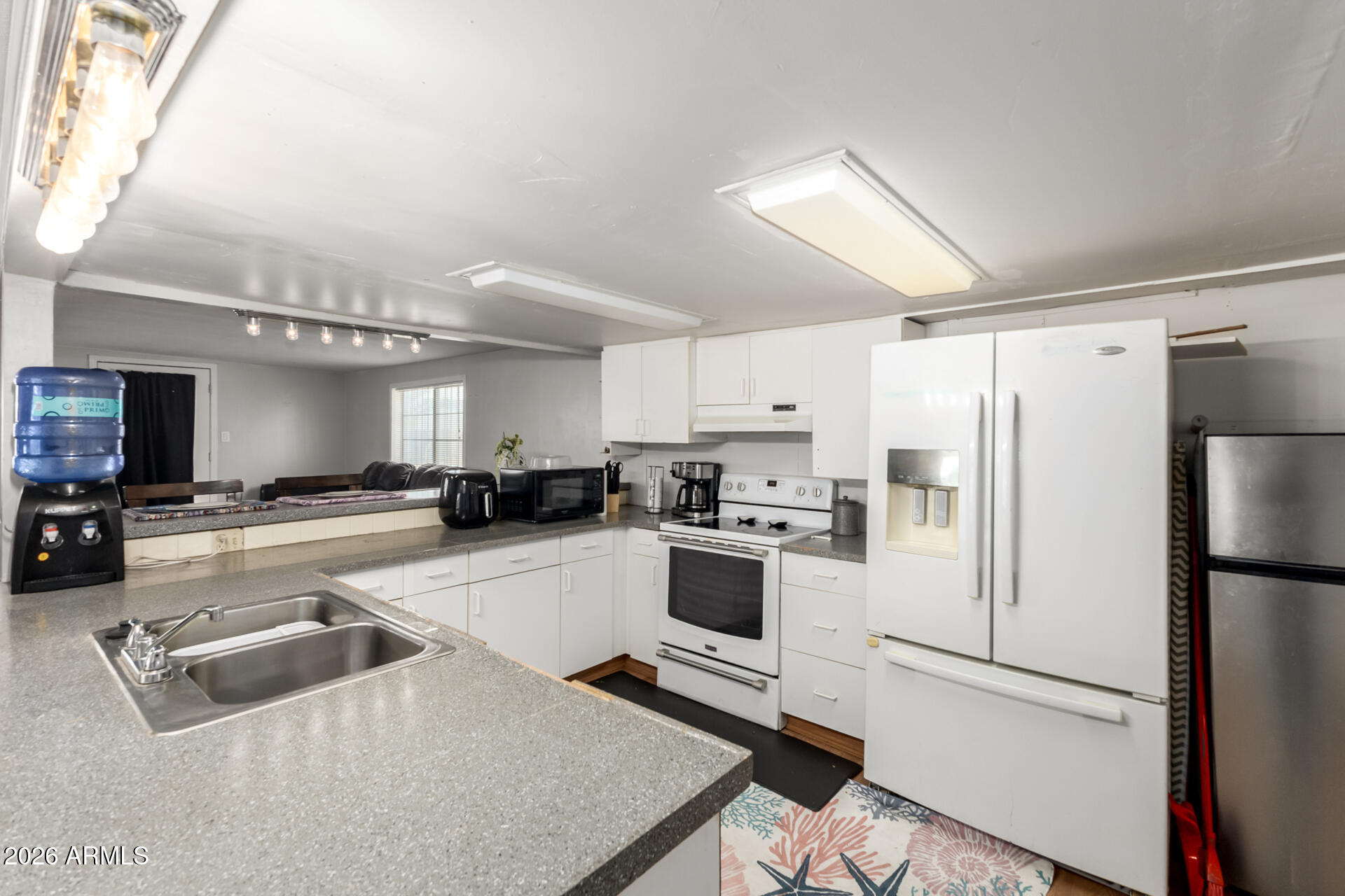 157 North 113th Way Apache Junction, AZ 85120 - Photo 11 of 27 a kitchen with refrigerator and cabinets