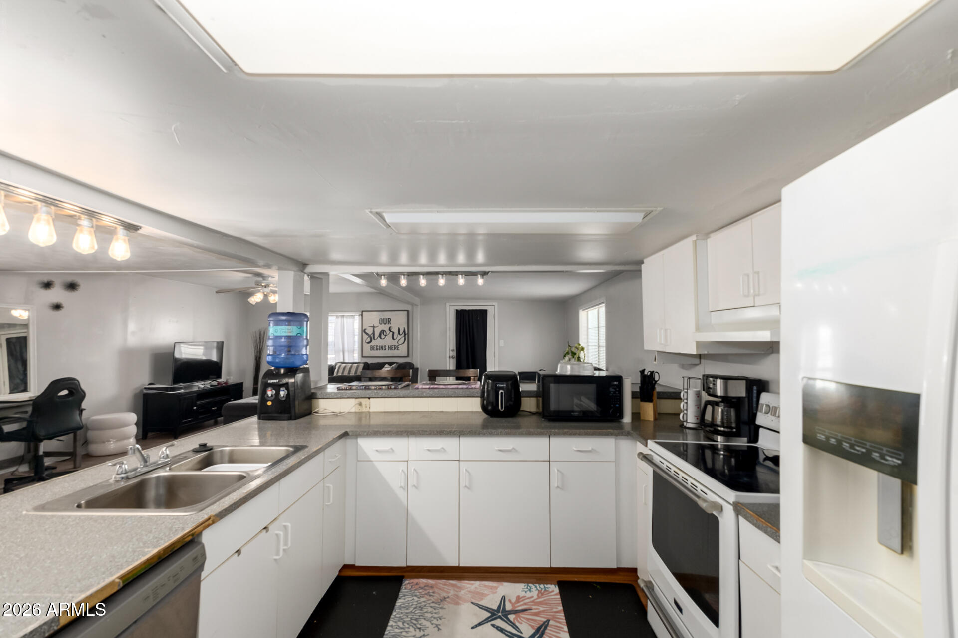 157 North 113th Way Apache Junction, AZ 85120 - Photo 12 of 27 a kitchen with stainless steel appliances a sink a stove top oven a counter space and cabinets