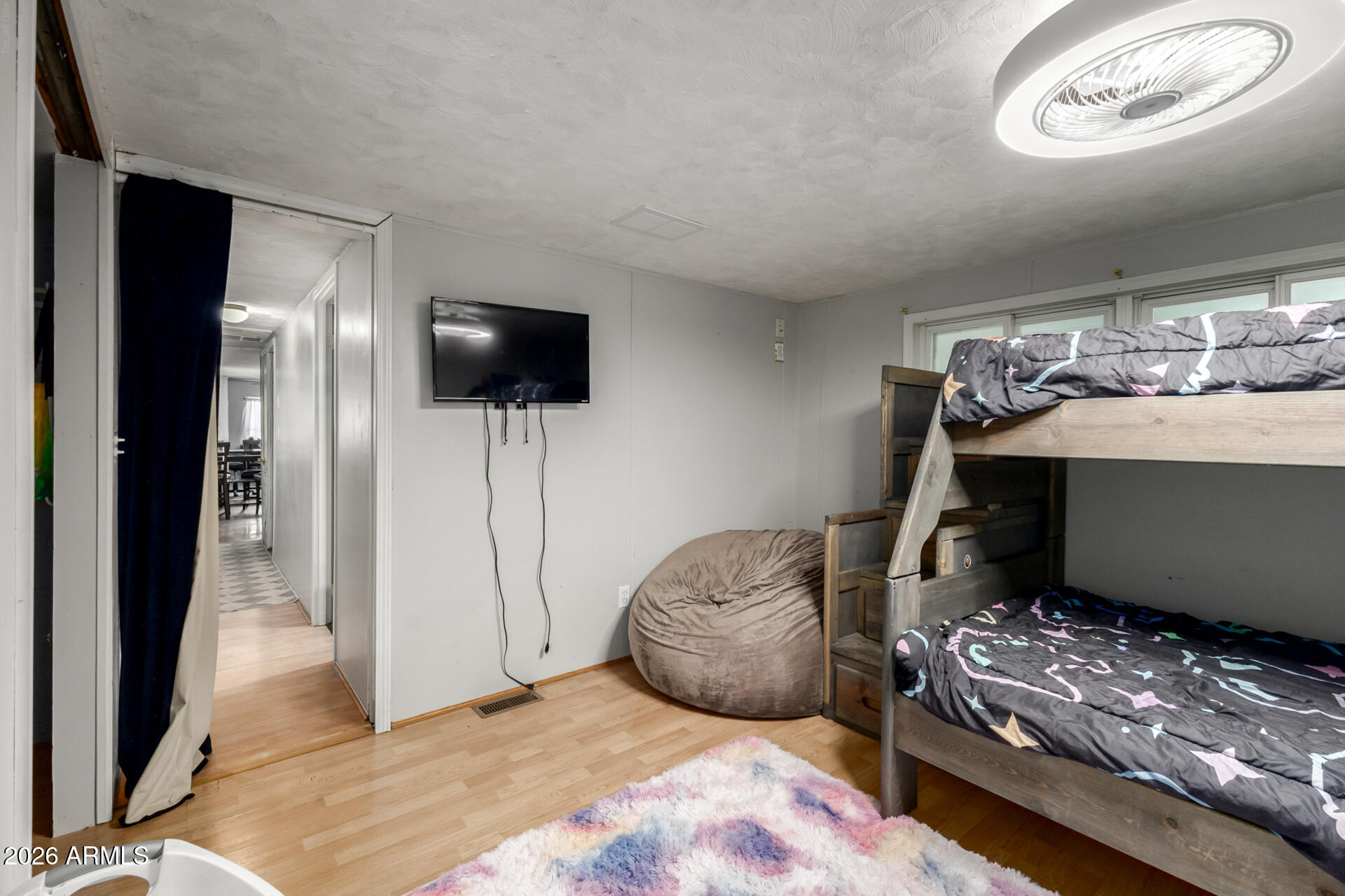 157 North 113th Way Apache Junction, AZ 85120 - Photo 18 of 27 a bedroom with furniture and flat screen tv