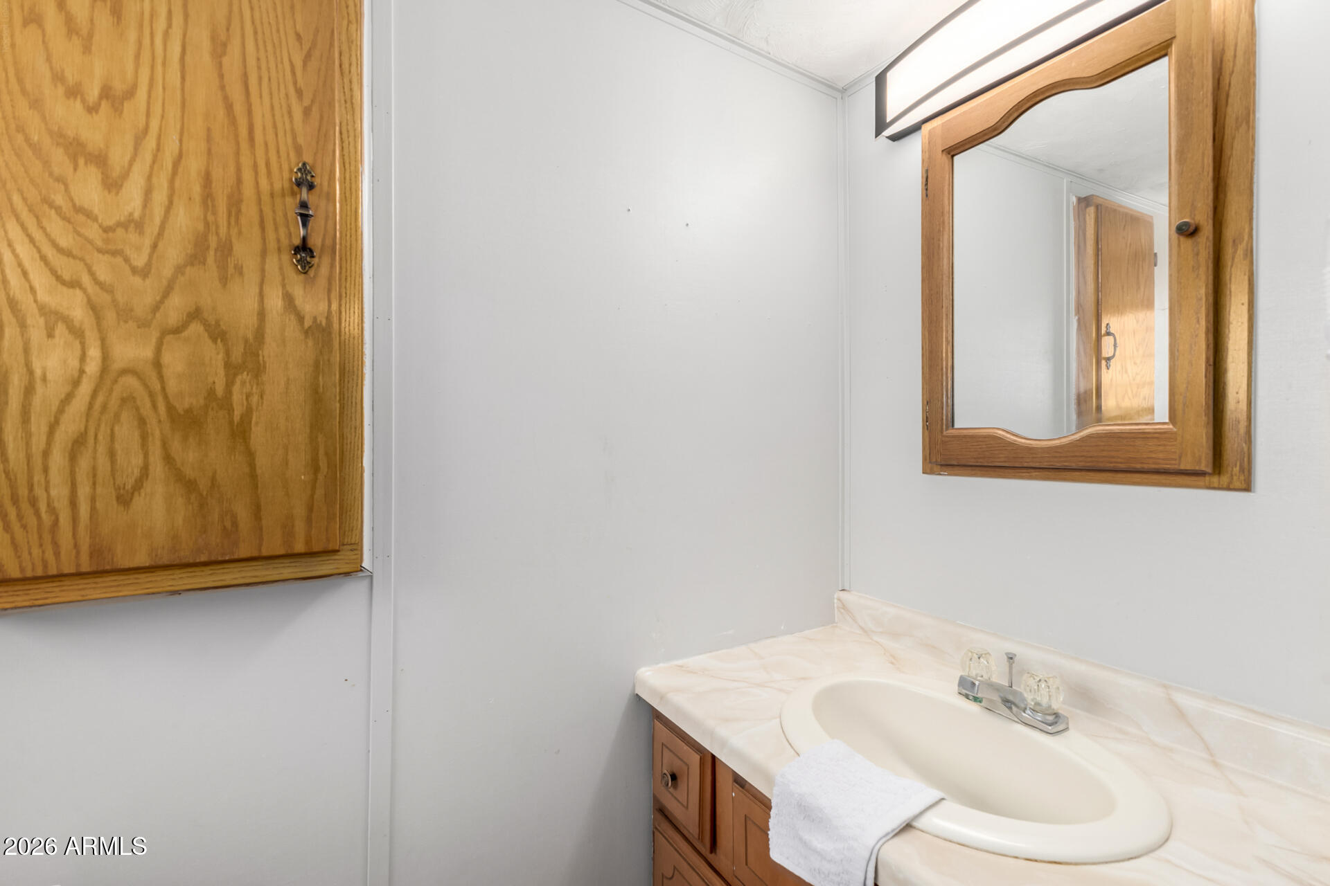157 North 113th Way Apache Junction, AZ 85120 - Photo 19 of 27 a bathroom with a sink and a mirror