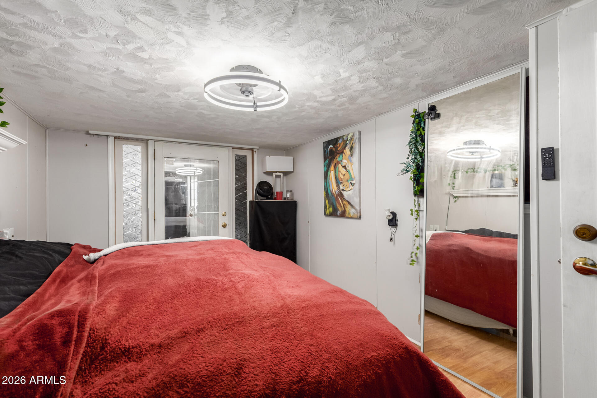 157 North 113th Way Apache Junction, AZ 85120 - Photo 20 of 27 a bedroom with a bed and a chair