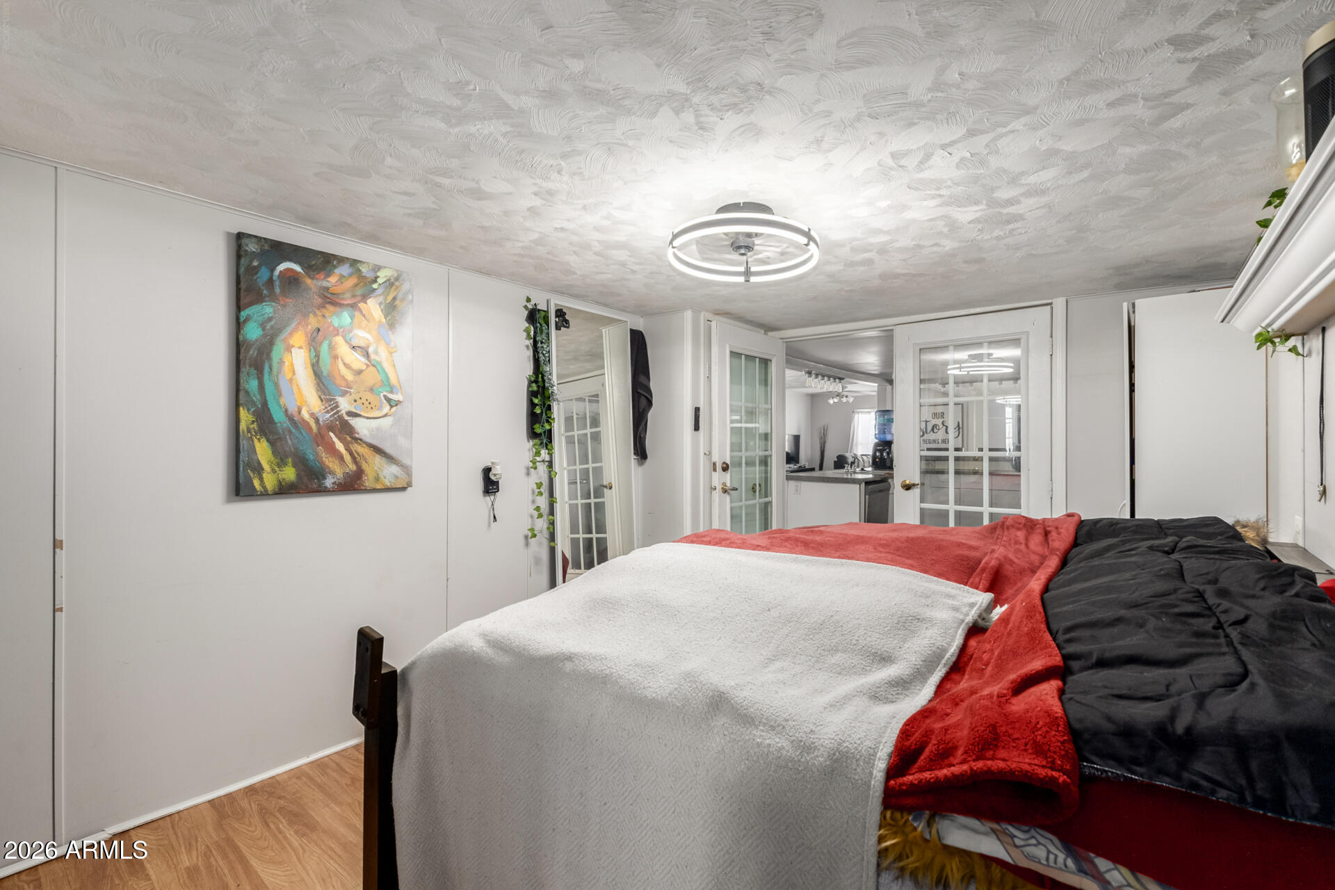 157 North 113th Way Apache Junction, AZ 85120 - Photo 21 of 27 a bedroom with a bed and a painting on the wall