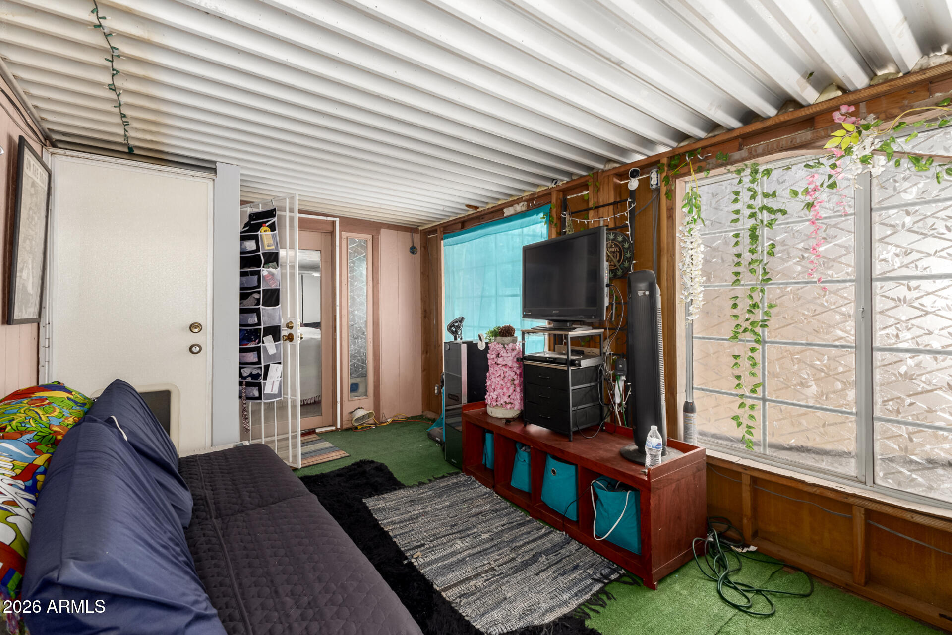 157 North 113th Way Apache Junction, AZ 85120 - Photo 24 of 27 a living room with furniture a flat screen tv and a large window