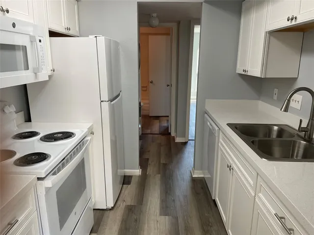 a kitchen with a refrigerator sink and stove