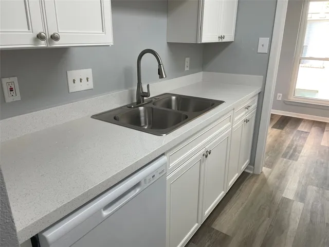 a close view of a sink a faucet and appliance in the kitchen