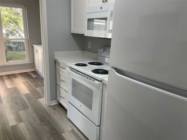 a stove top oven sitting inside of a kitchen