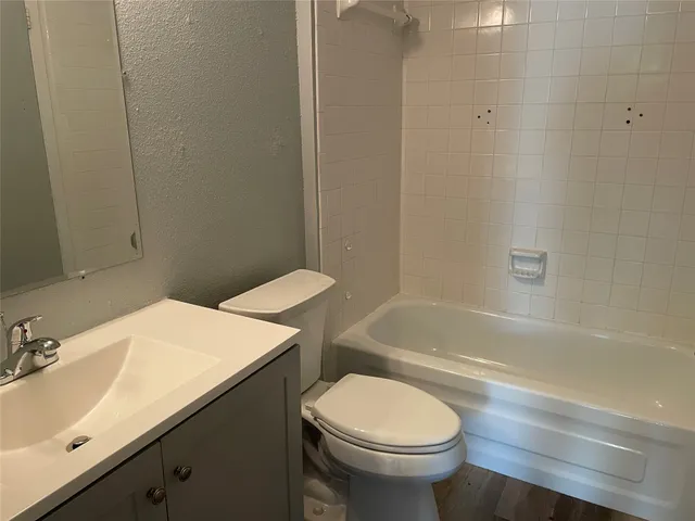 a bathroom with a sink a toilet and bathtub