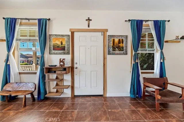 a view of a livingroom with lounge chair and a window