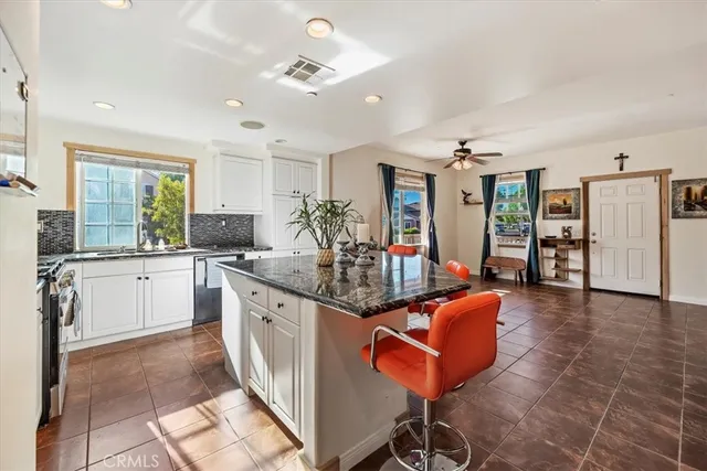 a large white kitchen with a large window