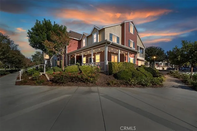 a front view of a house with a garden