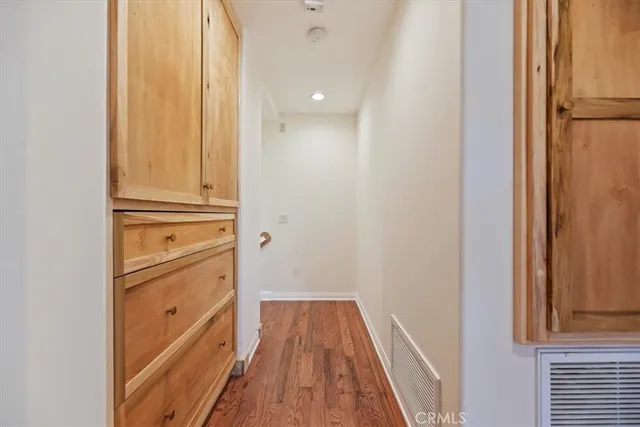 a view of a hallway with wooden floor