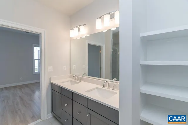 a bathroom with a double vanity sink and a mirror