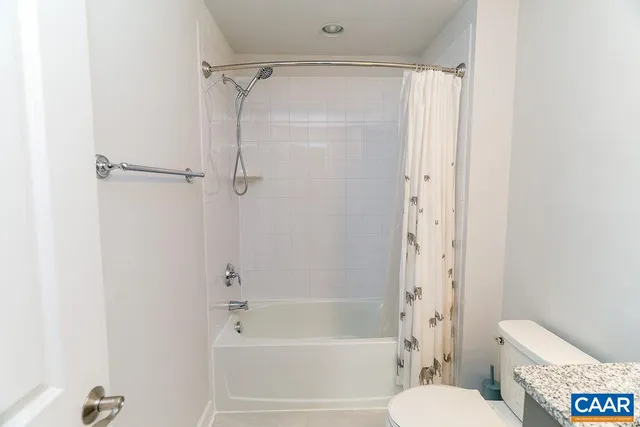 a view of a room with wooden floor and windows