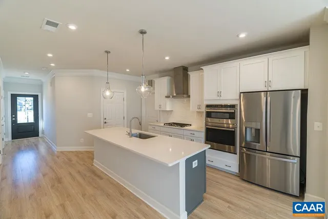 a kitchen with a sink stainless steel appliances and refrigerator