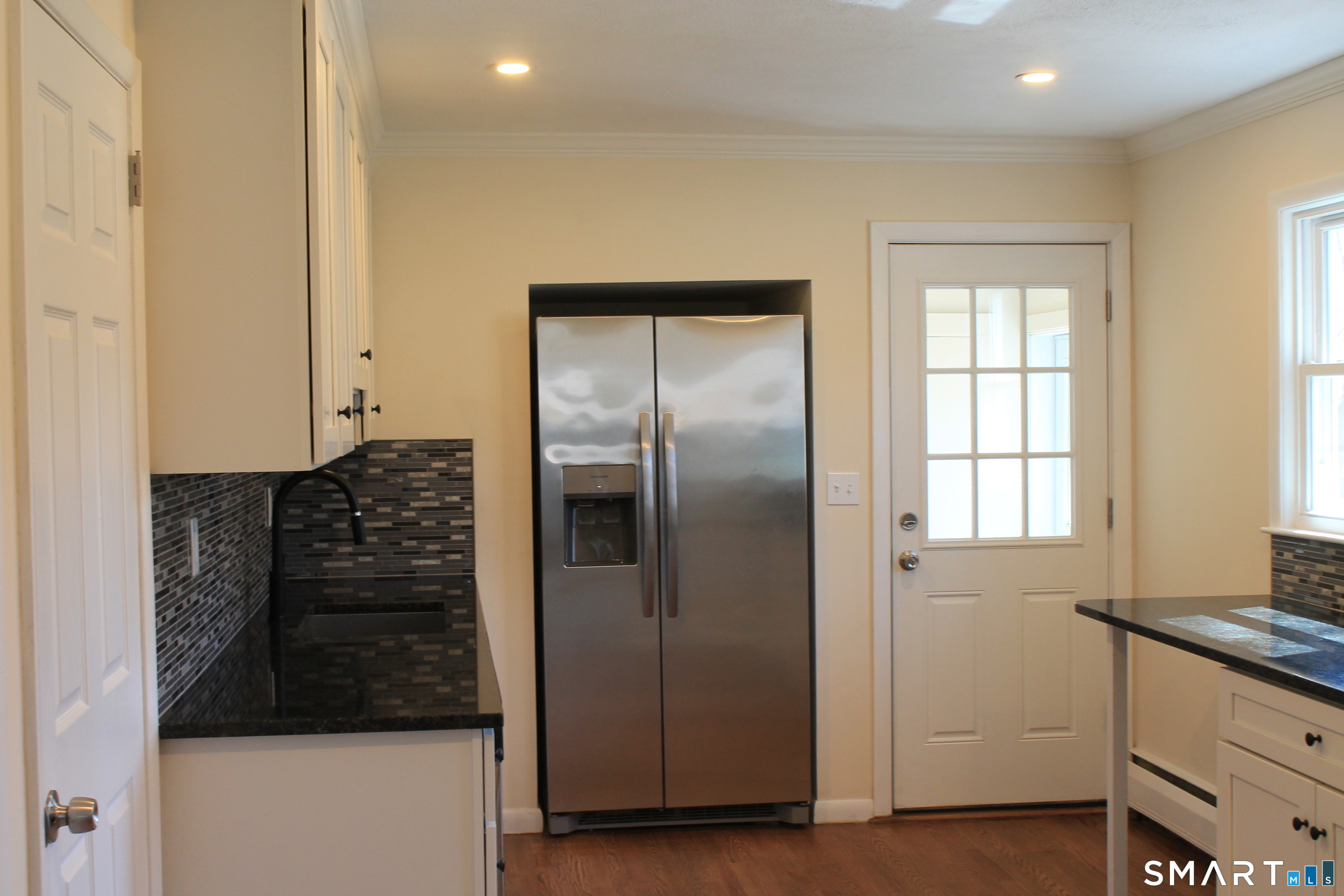 134 Sunset Street Windsor Locks, CT 06096 - Photo 8 of 23 a kitchen with granite countertop a refrigerator and a stove top oven