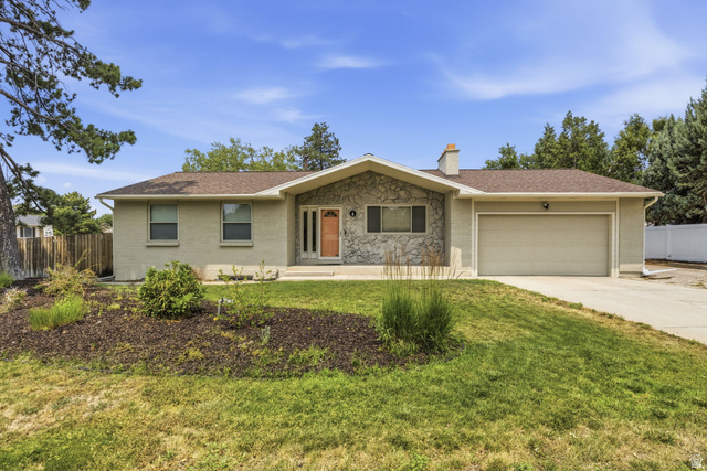 2693 Teal Way Sandy, UT 84093 - Photo 1 of 50 Ranch-style residence featuring a prominent stone facade accent, a light-colored brick exterior, and a two-car garage with an overhead door