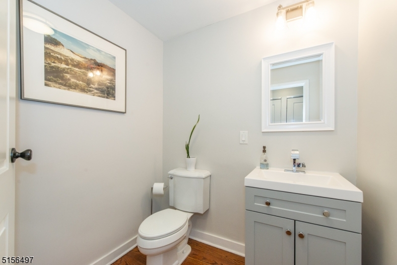32 Parsonage Hill Road Short Hills, NJ 07078 - Photo 20 of 49 a bathroom with a toilet sink and mirror