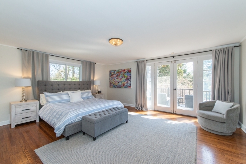 32 Parsonage Hill Road Short Hills, NJ 07078 - Photo 21 of 49 a bedroom with a large bed and a couch next to a window
