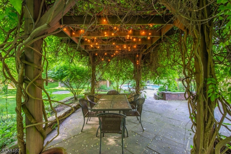 32 Parsonage Hill Road Short Hills, NJ 07078 - Photo 38 of 49 a view of a chairs and table in a backyard