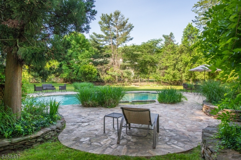 32 Parsonage Hill Road Short Hills, NJ 07078 - Photo 40 of 49 a view of a bench in the garden near a lake