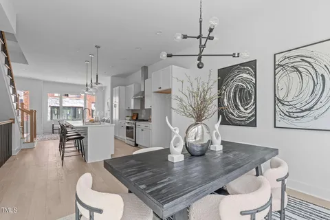 a view of a dining room with furniture and wooden floor