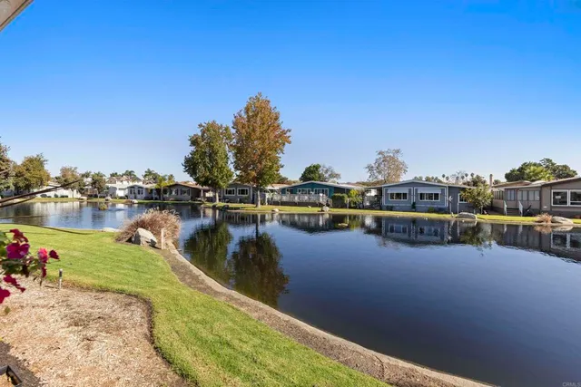 a view of a lake with boats and trees in the background