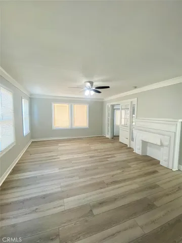 a view of a kitchen with wooden floor and a ceiling fan