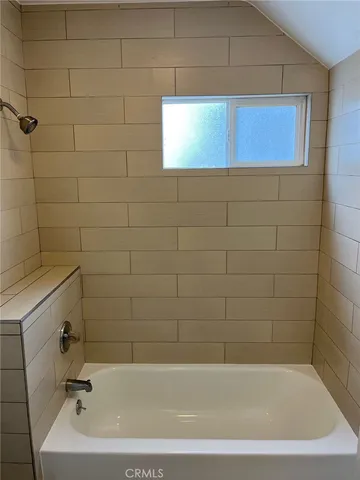 a kitchen with granite countertop a stove a sink and a cabinets