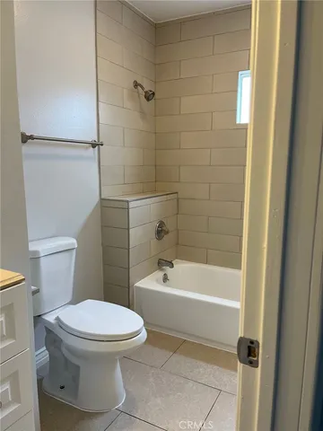 a view of an empty room and window and wooden floor