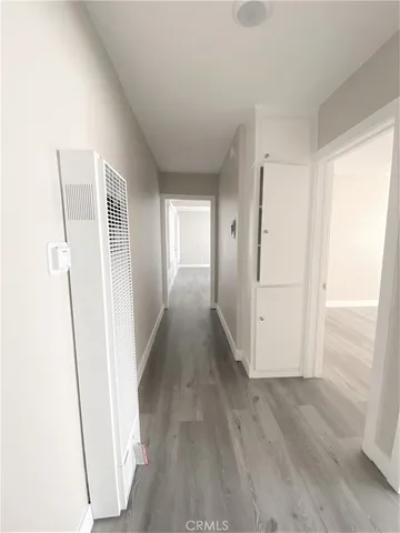 a view of empty room with wooden floor