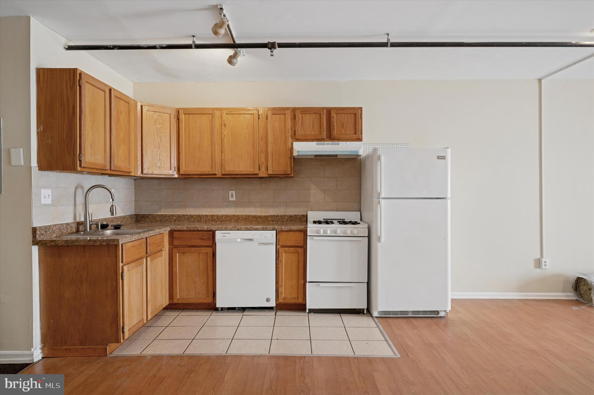 128 North 3rd Street, Unit 2R Philadelphia, PA 19106 - Photo 11 of 16 a kitchen with a sink a stove and cabinets