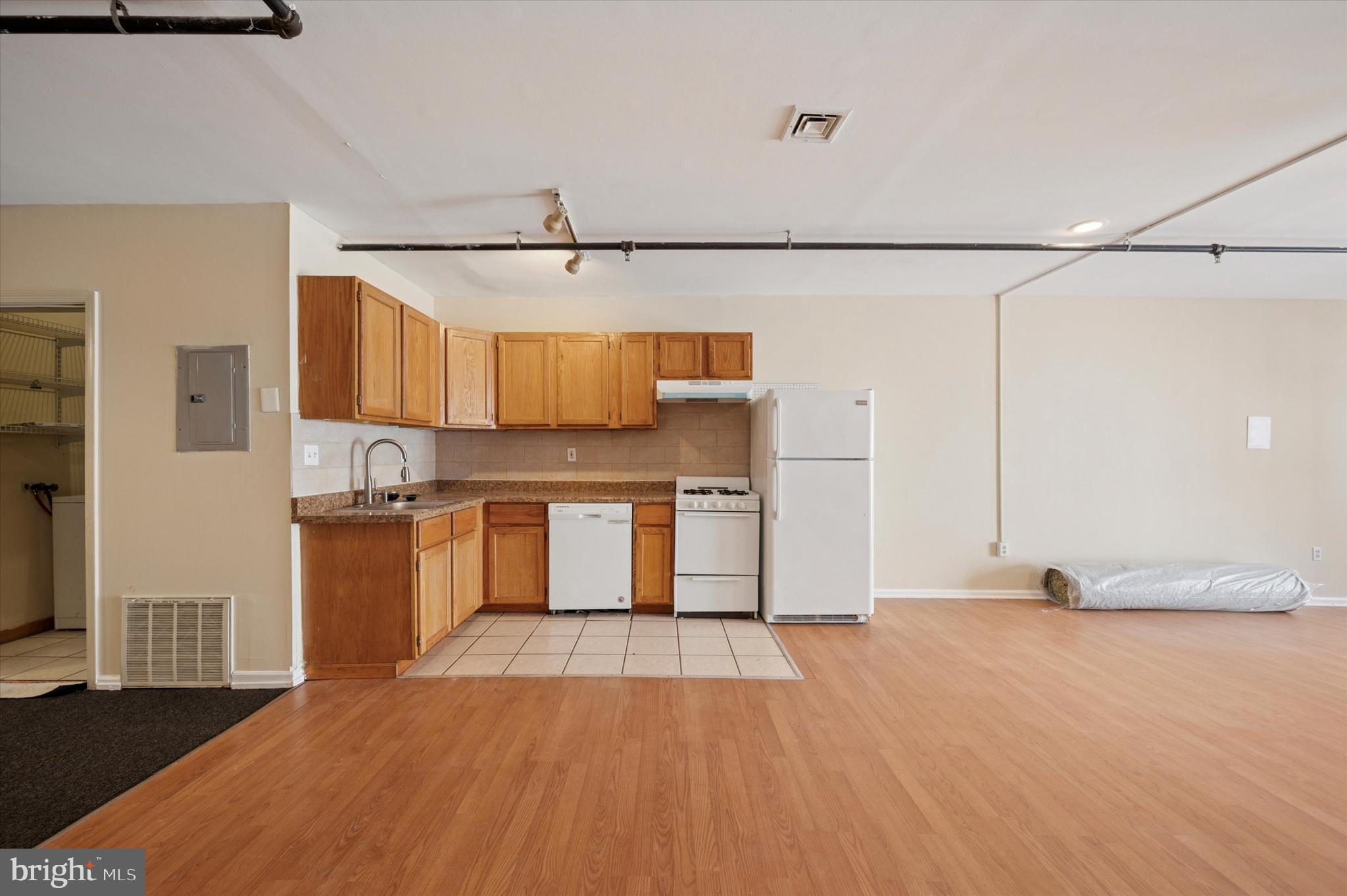 128 North 3rd Street, Unit 2R Philadelphia, PA 19106 - Photo 10 of 16 a open kitchen with stainless steel appliances granite countertop a sink and a refrigerator
