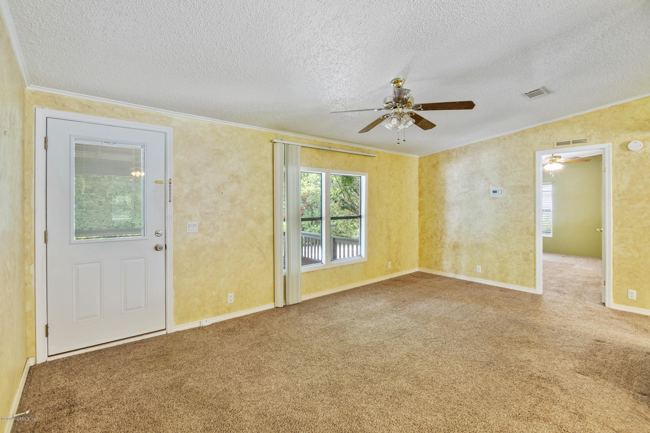 1665 Scott Road St. Johns, FL 32259 - Photo 28 of 54 an empty room with chandelier fan and windows