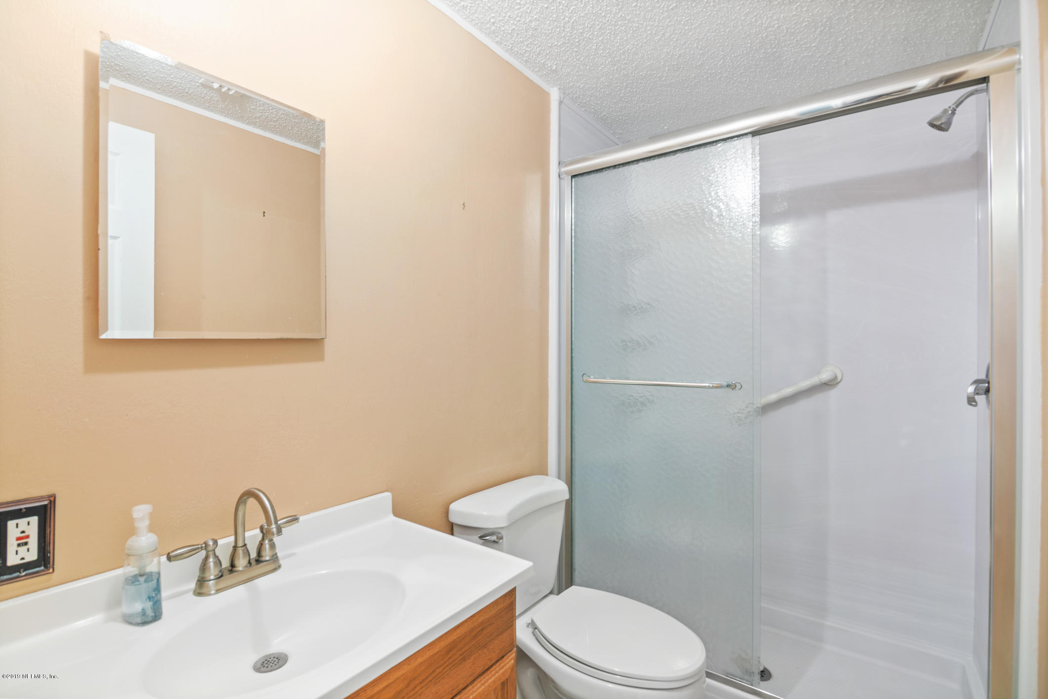 1665 Scott Road St. Johns, FL 32259 - Photo 29 of 54 a bathroom with a sink mirror vanity and toilet