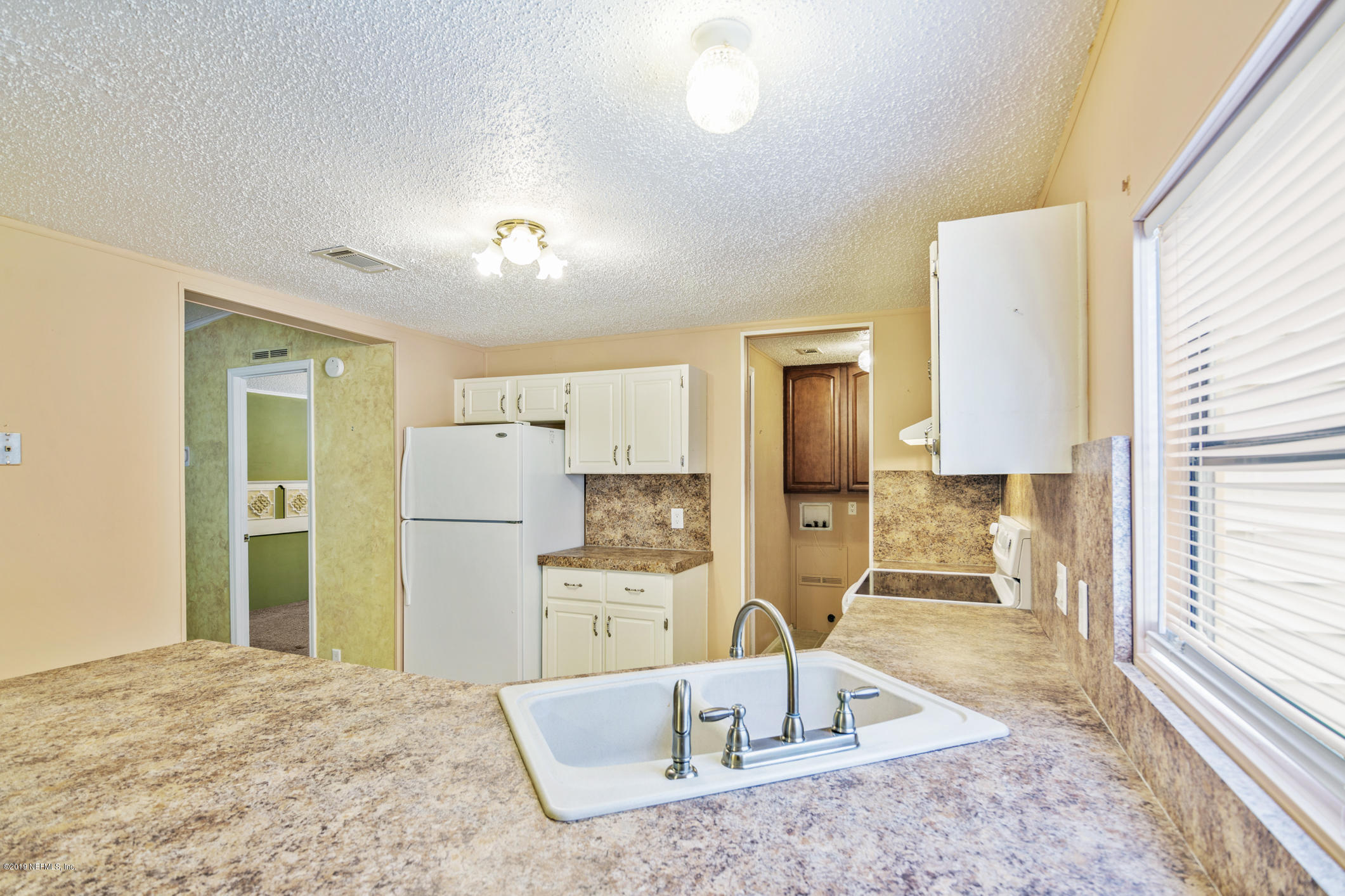1665 Scott Road St. Johns, FL 32259 - Photo 34 of 54 a kitchen with kitchen island a sink appliances and cabinets