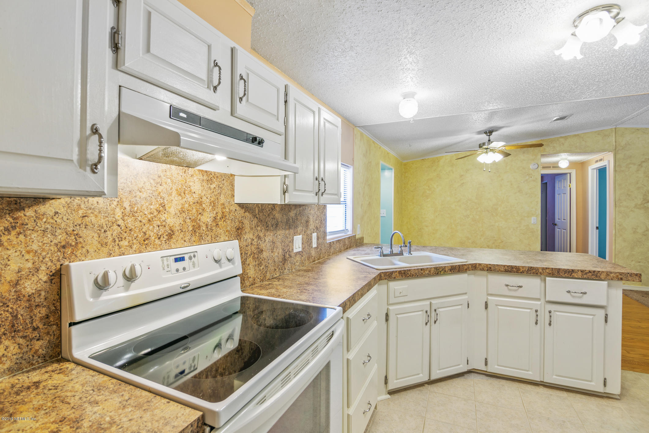 1665 Scott Road St. Johns, FL 32259 - Photo 36 of 54 a kitchen with white cabinets appliances and a window