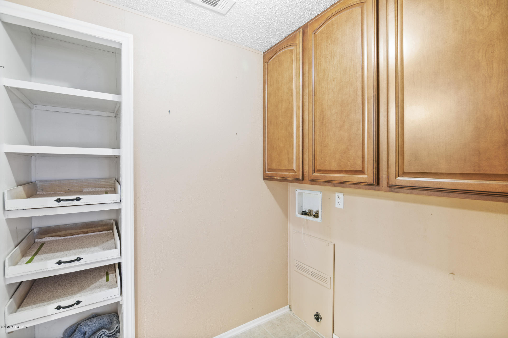 1665 Scott Road St. Johns, FL 32259 - Photo 37 of 54 a view of cabinet with washer and dryer