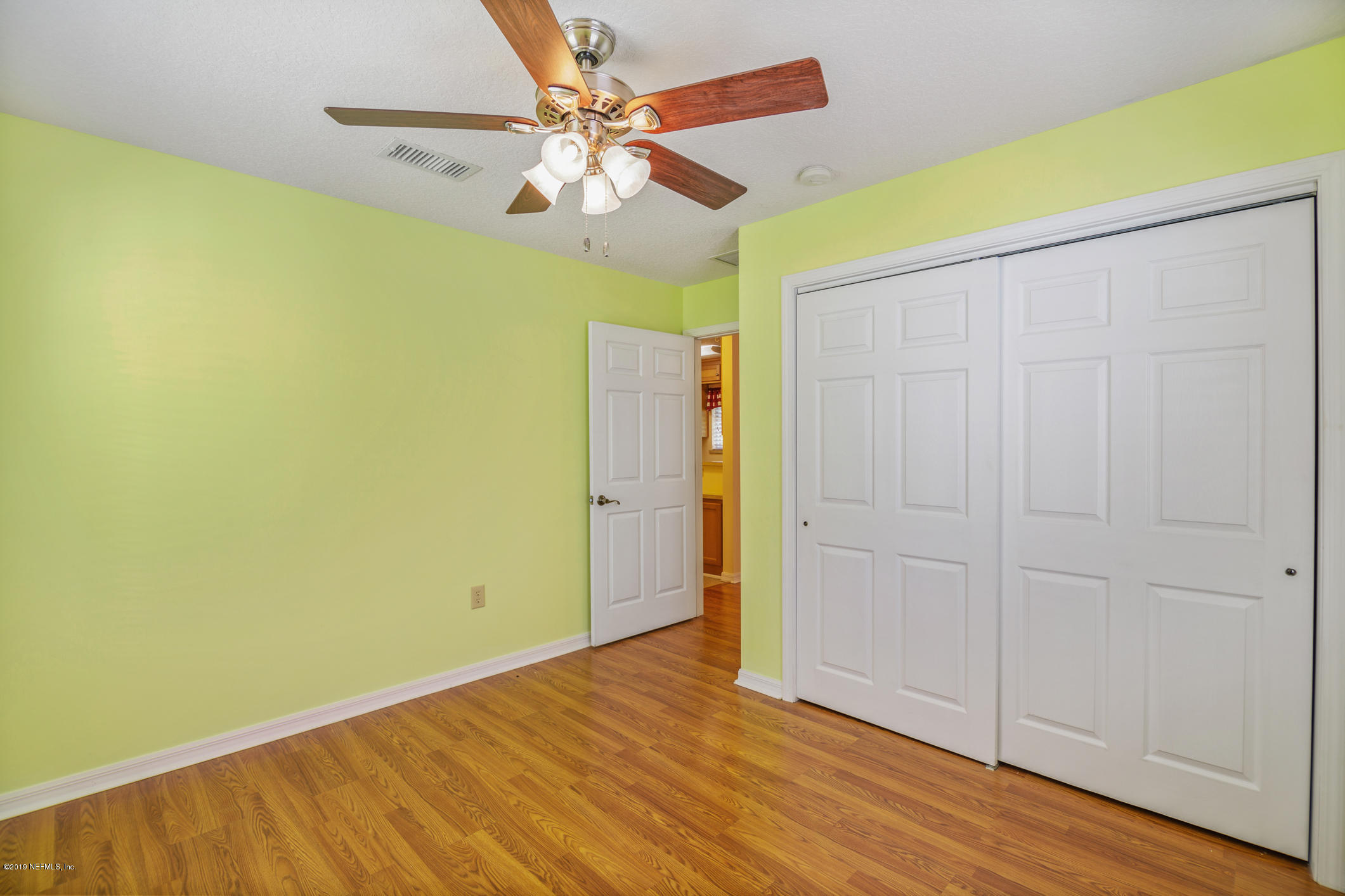 1665 Scott Road St. Johns, FL 32259 - Photo 47 of 54 an empty room with wooden floor fan and windows