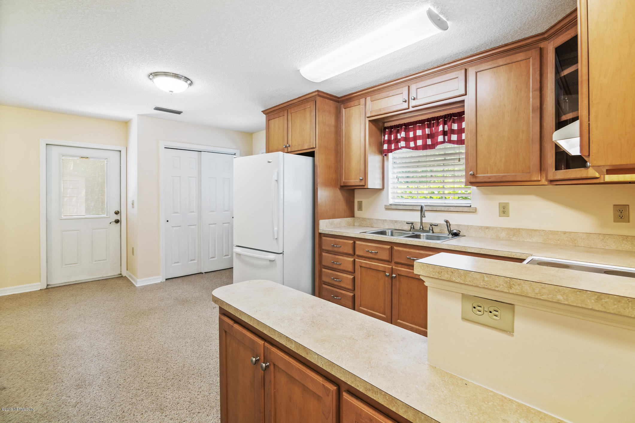 1665 Scott Road St. Johns, FL 32259 - Photo 48 of 54 a kitchen with a refrigerator sink and cabinets