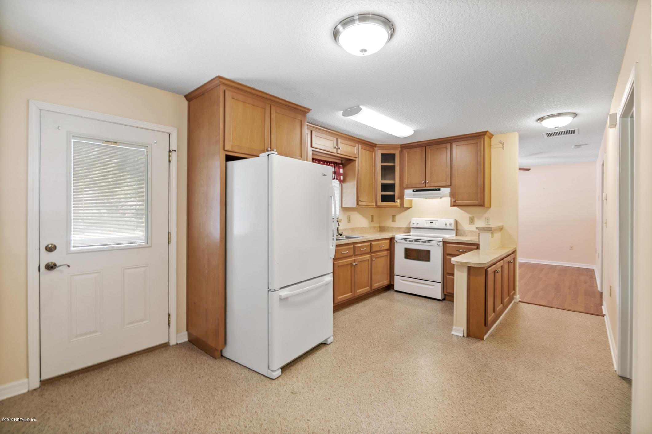 1665 Scott Road St. Johns, FL 32259 - Photo 49 of 54 a kitchen with a refrigerator a sink and cabinets