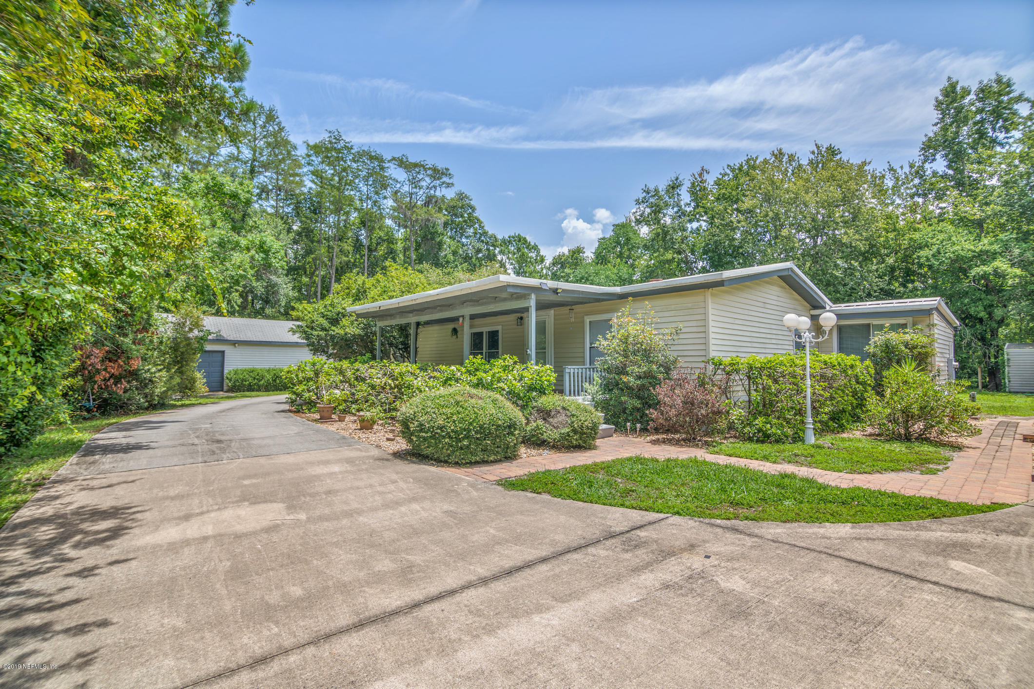 1665 Scott Road St. Johns, FL 32259 - Photo 7 of 54 a front view of a house with a yard and potted plants